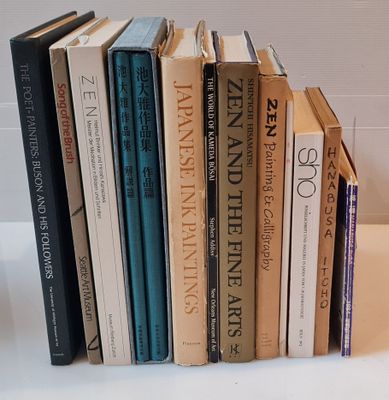 several books are stacked on top of each other on a table