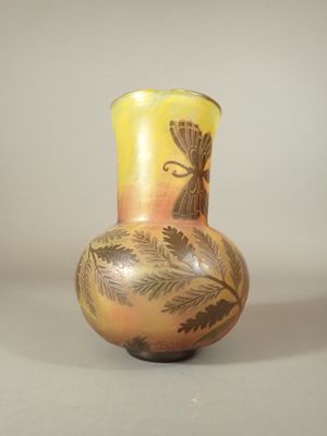 a vase with a design on it sitting on a table