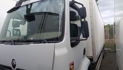 a white truck that is parked next to a building