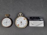 three different types of pocket watches on a table