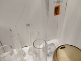 a lot of glass vases and a bowl on the table
