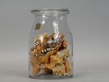 a glass jar filled with sea shells and shells