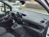 the interior of a small car with a steering wheel and dashboard