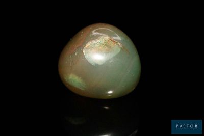 an image of a green jade stone on a black surface