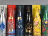 bottles of different types and colors are lined up on a table