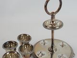 a silver plate with silver cups on it and a silver plate with silver cups on it