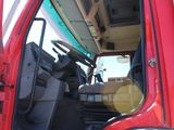 a red truck with the door open and the driver ' s seat down