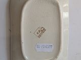 a white plate with a small square on it