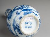 a blue and white vase sitting on a table