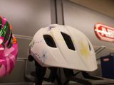 two helmets that are sitting on a shelf in a room