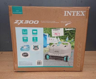 the box is open to show the contents of a robotic lawn mower
