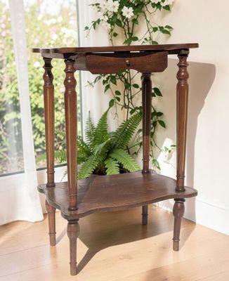 a wooden table with a plant on top of it
