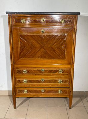 a wooden chest of drawers with a marble top