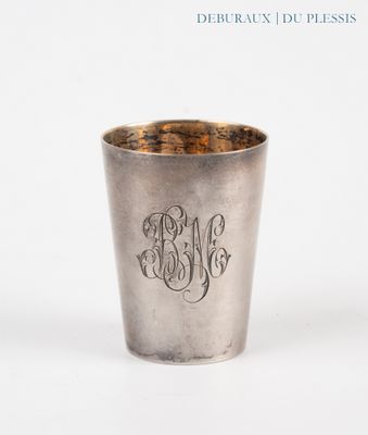 a silver cup that has a monogram on it