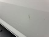 a close up of a car door with a small crack in it