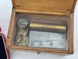 a wooden box with a musical box inside of it