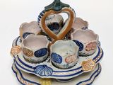 a blue and white plate with a heart shaped bowl on it