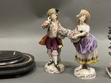 three figurines sitting next to each other on a table