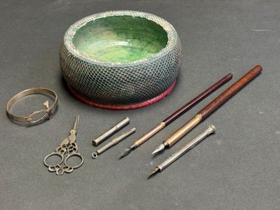 a bowl, scissors, and other items that are on the table