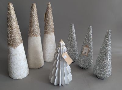 a lot of christmas trees that are sitting on a table