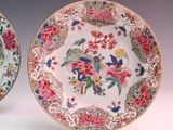 pair of chinese plates with flowers and birds on them on a white surface