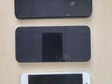three cell phones that are sitting on a table