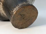 a close up of a metal object with writing on it