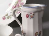 a cup and saucer sitting next to a plate on a table