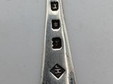 a silver spoon with a black and white design on it