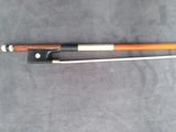 a close up of a violin bow on a gray surface