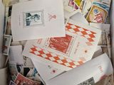a box full of stamps and envelopes sitting on a table