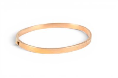 a close up of a gold bracelet on a white background