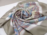 scarf on a white table cloth with a flower design on it