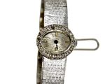 an image of a woman ' s wrist watch with a diamond bezel