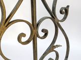 wrought iron table with a glass top on a white background