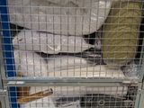a shopping cart with a lot of bags of white stuff in it