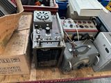 a pile of electronics on a table in a warehouse
