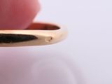 a person holding a gold ring with a diamond in it