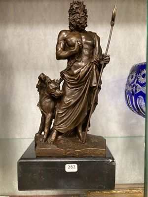 a statue of a man with a dog in a glass case