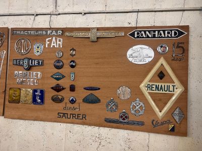 a wooden board with many different types of badges on it