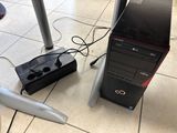 a desktop computer sitting on the floor next to a charger