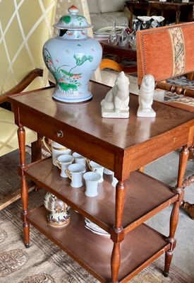 une petite table sur laquelle se trouve un vase, au milieu d'un salon