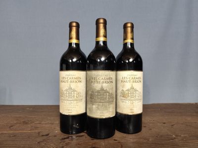 three bottles of wine sitting on top of a wooden table