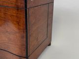 a small wooden box with two drawers on wheels