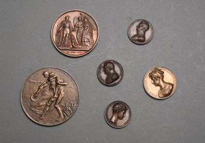 four different types of coins are shown on a gray surface