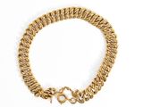 a close up of a gold bracelet on a white background