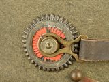 a close up of a military hat with a red button on it