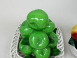 a basket of green apples and a bowl of peaches
