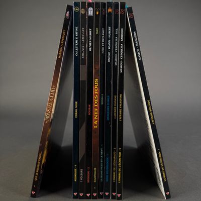 three books stacked on top of each other on a table