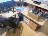a desk with a chair and a computer on it